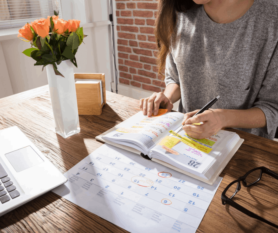 Woman sitting at a desk creating a schedule